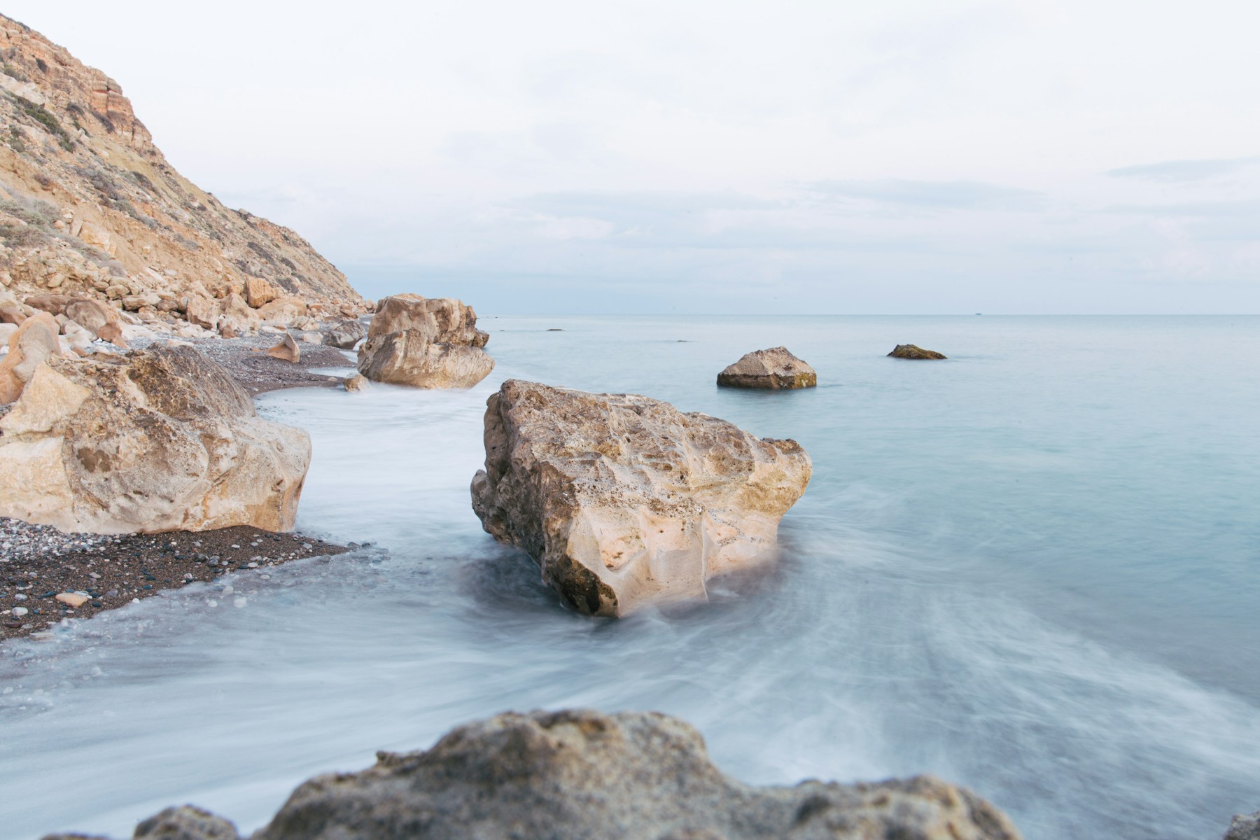 A broad stretch of quiet water and a pale natural shoreline.